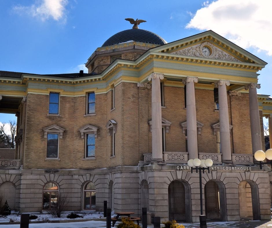 Front view of Garrett County Courthouse with columns and dome in Oakland, Maryland.