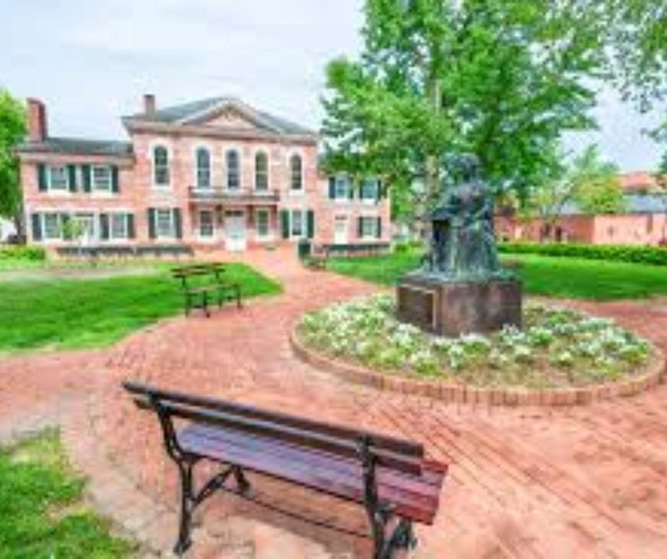 Historic courthouse building and park area in Queen Anne's County Maryland with statue and benches