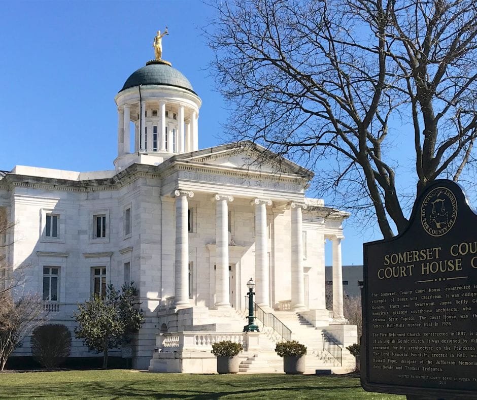 The historic white marble Somerset County Court House featuring a green dome with a gold statue and grand columns.