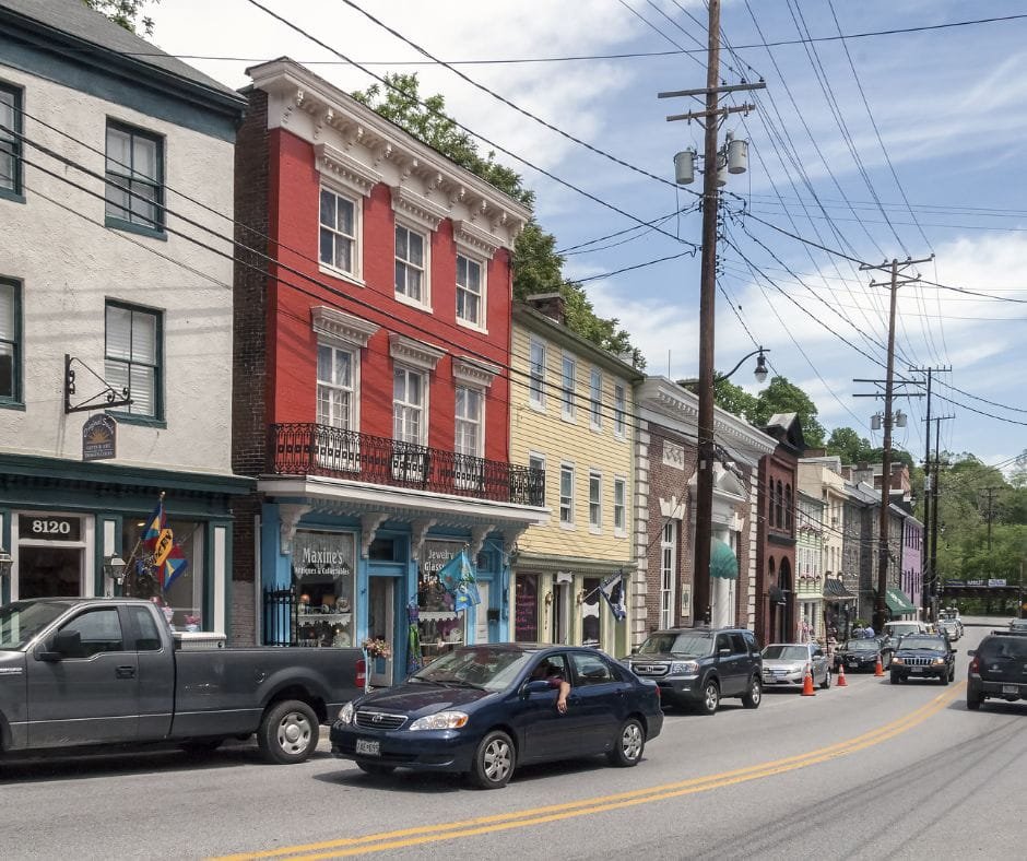 Historic main street with colorful buildings, small shops, and parked cars in a Maryland town.